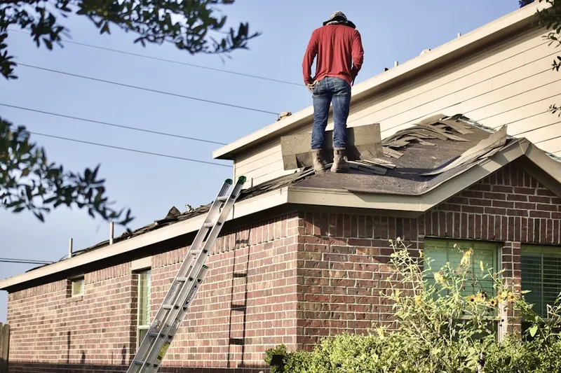 Professional roofer working on a residential roof in Mayodan